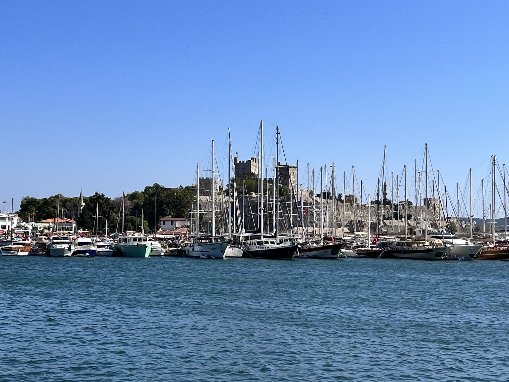 Photo of the Bodrum Marina on a sunny day with the castle in the background