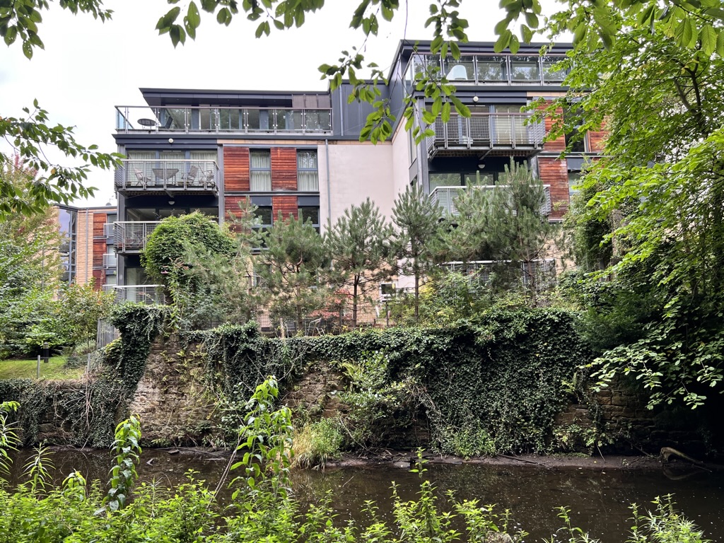Modern apartments at the edge of the Waters of Leith and pathway