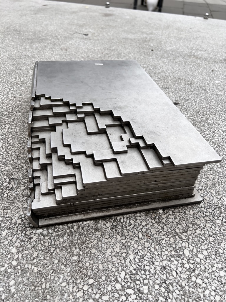 Photo of a street monument of a book with a cutaway design feature