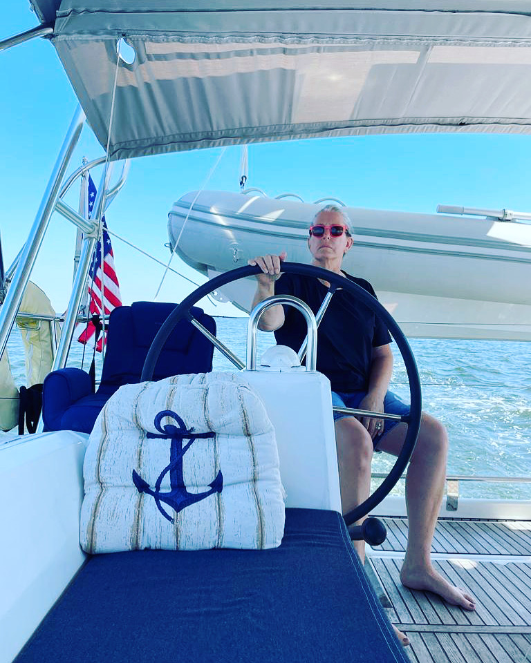 Photo of author behind the wheel of a sailboat