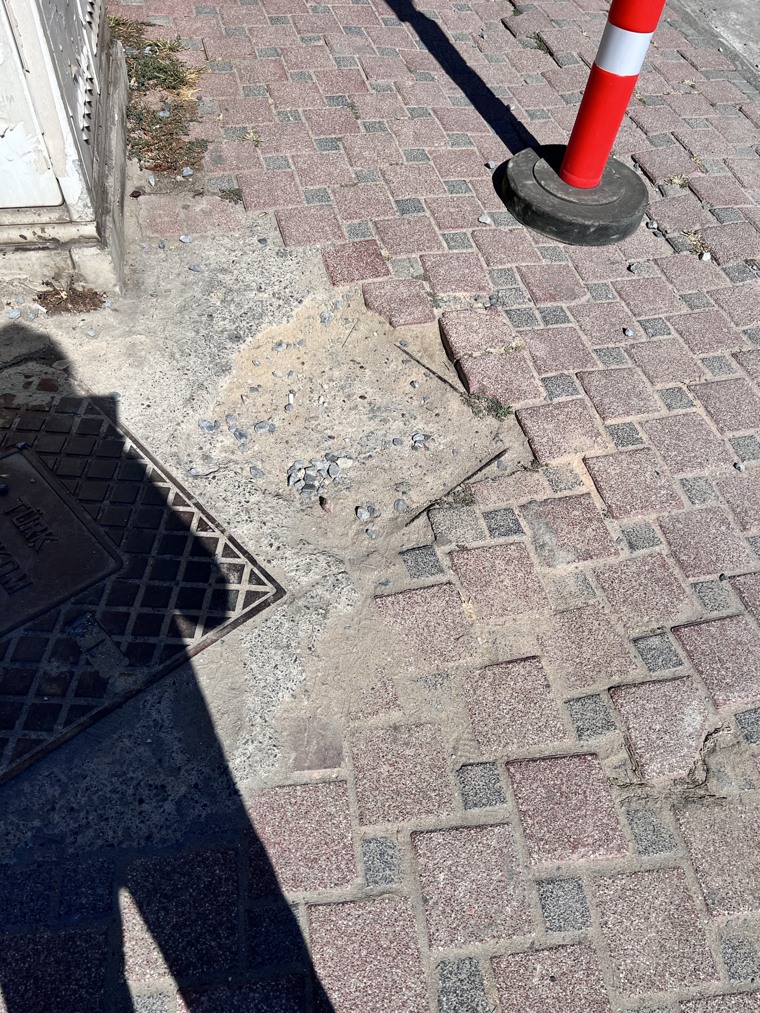 Sidewalk with filled hole near construction area